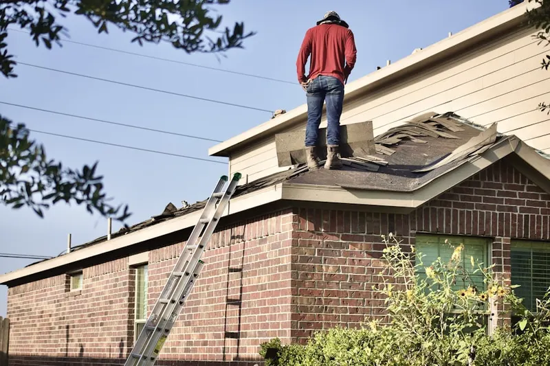 Professional roofer working on a residential roof in South Monrovia Island